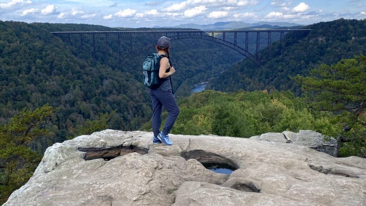 The author stands atop Long West point and looks down over West Virginia’s New River gorge and a bride spanning two green hillsides.