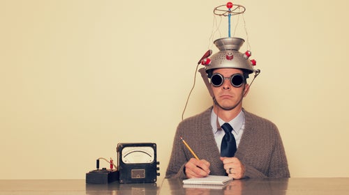 A scientist with a brain wave contraption on his head