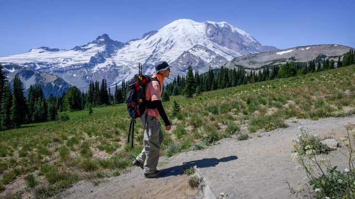 A man hikes Sunrise Trail at Washington鈥檚 Mount Rainier National Park in summer.