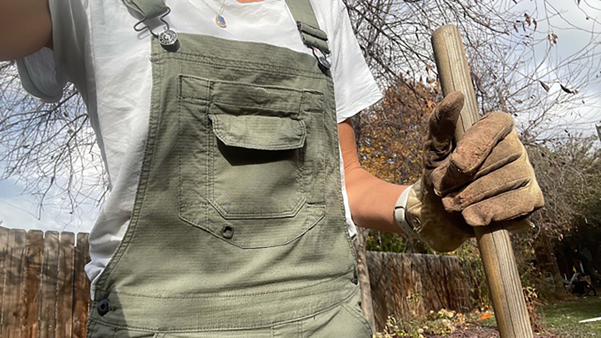 Dovetaill overalls on woman holding shovel