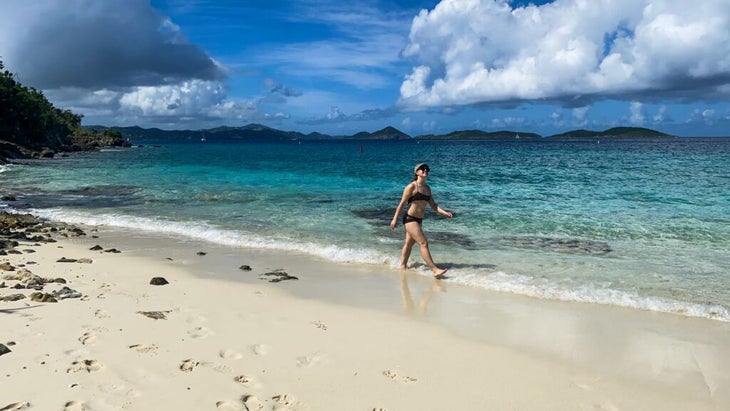 The author walks Salomon Beach, in the U.S. Virgin Islands, while turquoise waters lap at her feet.