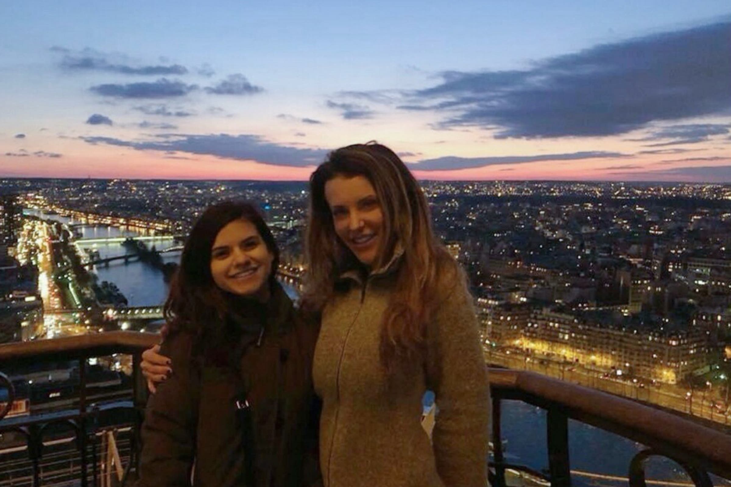 two women standing on a balcony