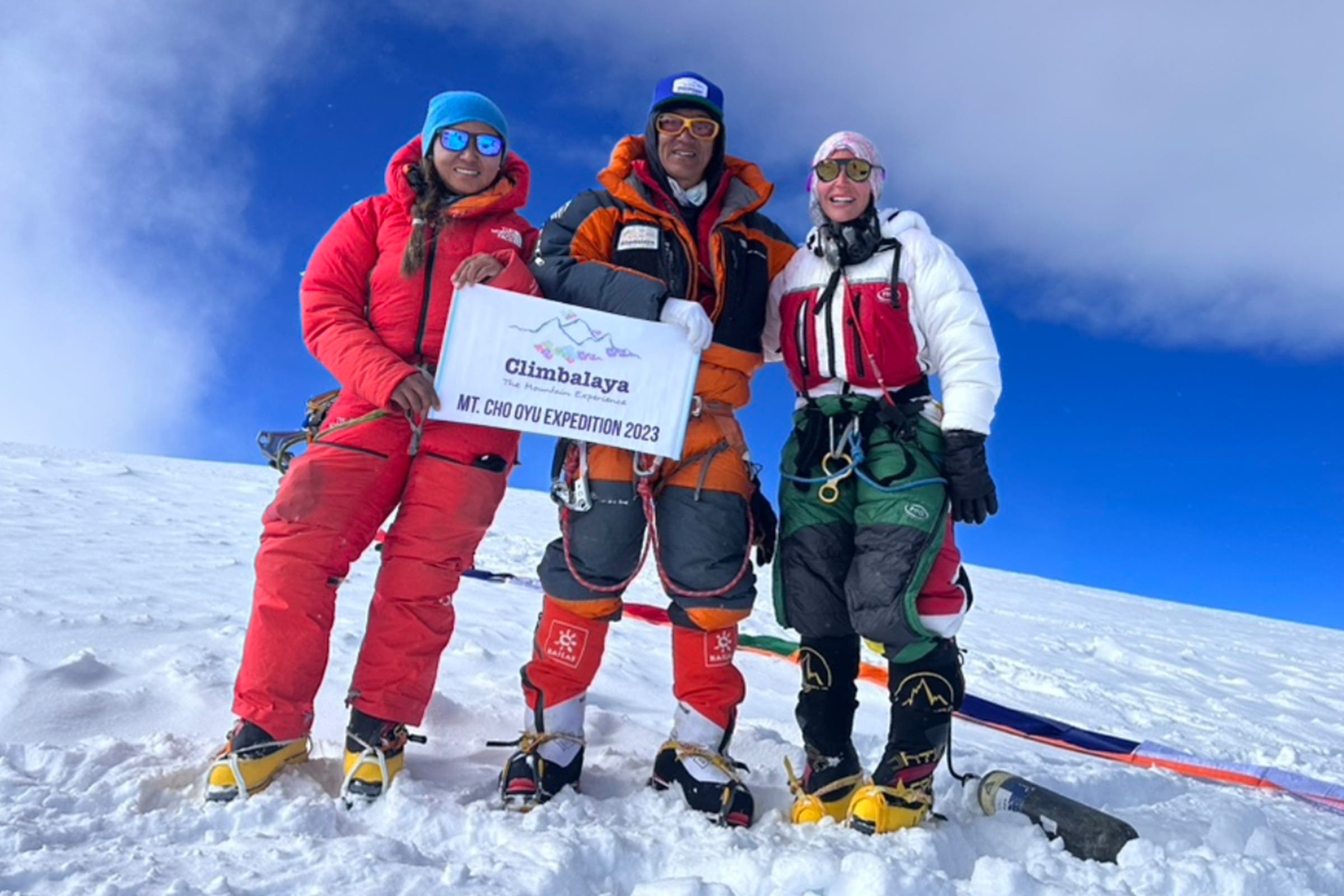 Three climbers on top of a mountain