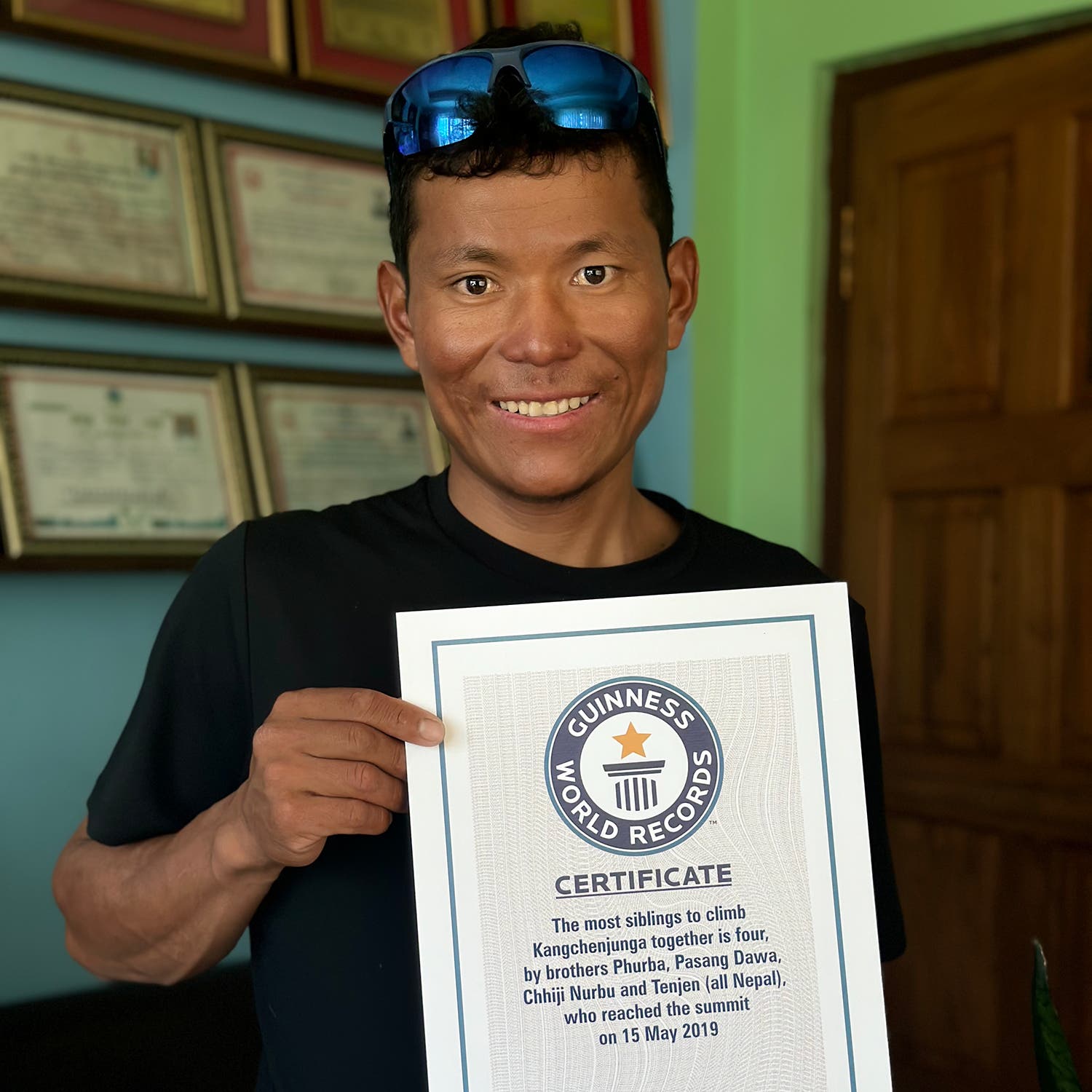 A man holds a certificate for setting a world record