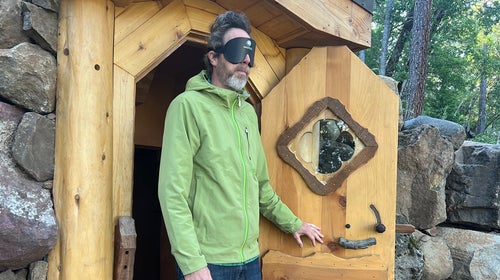 Tim Neville emerges from the dark after 82 hours, wearing a mask to protect his yes from the light.