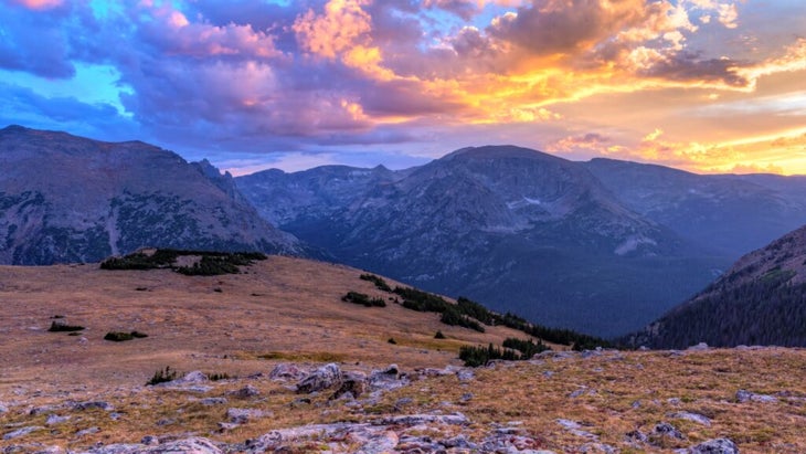 Sun sets over the Rockies as seen from the high-alpine tundra hills on the Ute Trail in Colorado’s Rocky Mountain National Park.