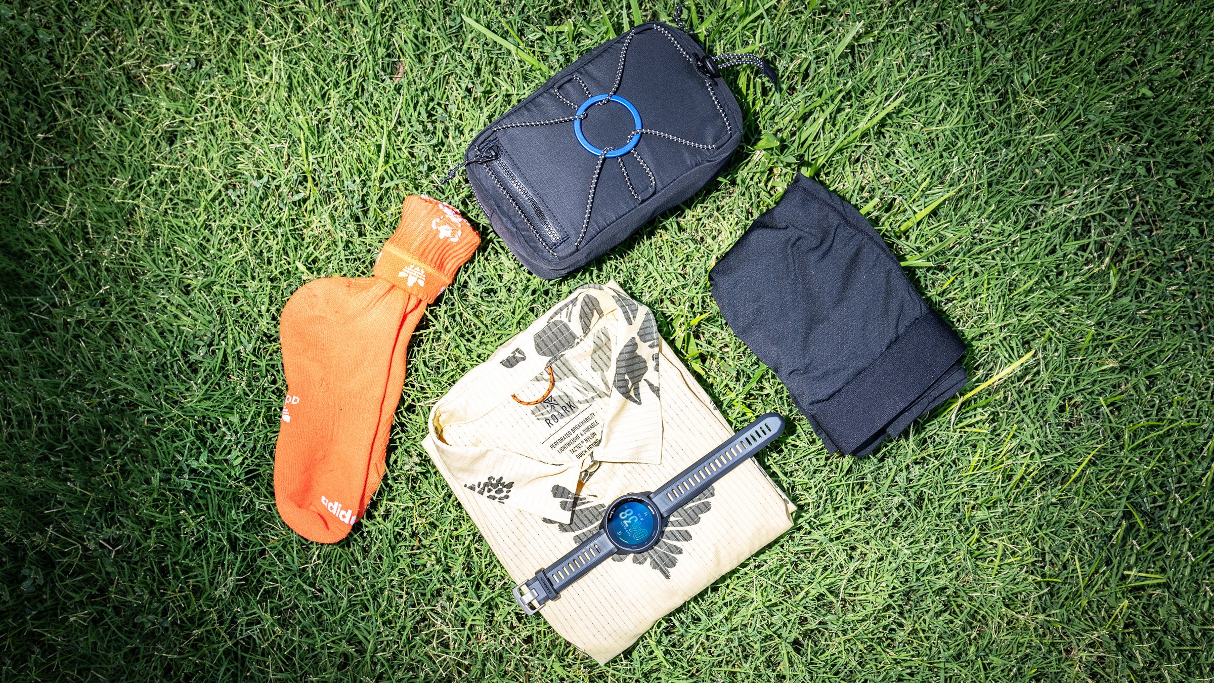5 pieces of running gear on a grass background