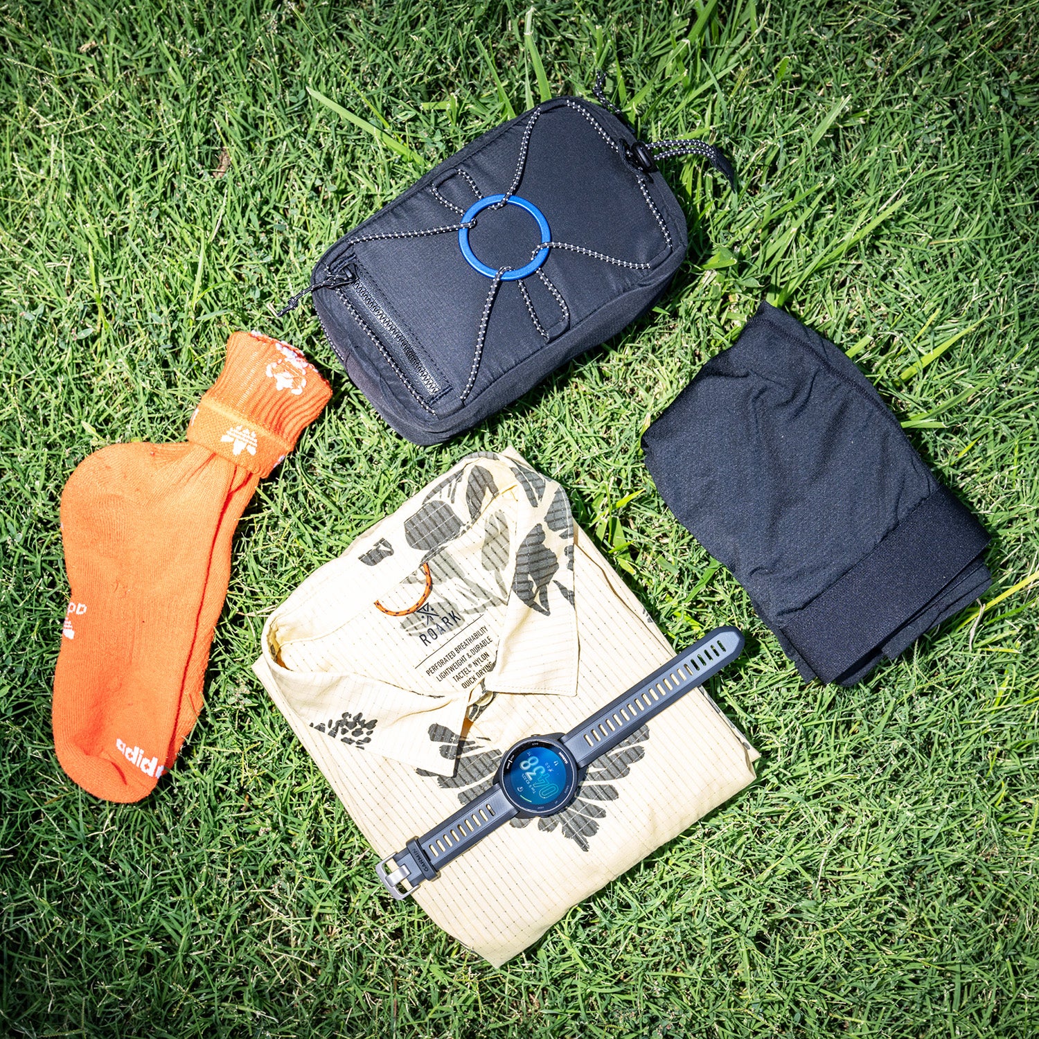 5 pieces of running gear on a grass background