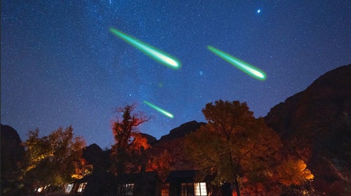 A night shot of the Grand Canyon’s Phantom Ranch with three superimposed fireballs in the sky above