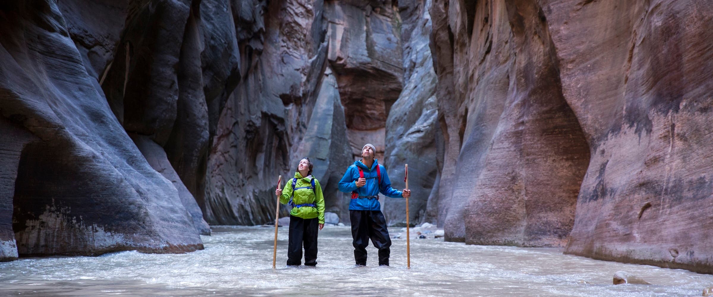 A couple hiking the Zion Narrows in Zion national Park.