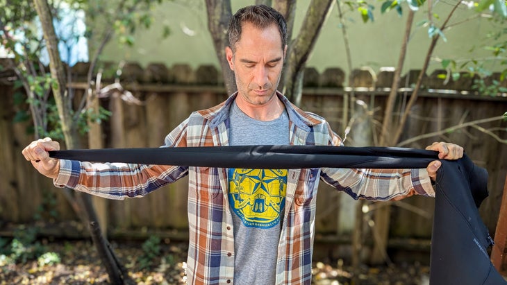 Tester stretching arms of Patagonia Yulex Regulator Wetsuit 