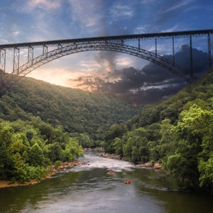 rafting below the New River Gorge Bridge in evening light