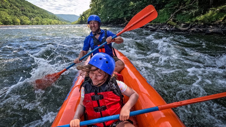 man and daughter boating in the Gauley