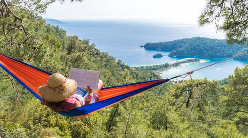 Woman Relaxing In Hammock