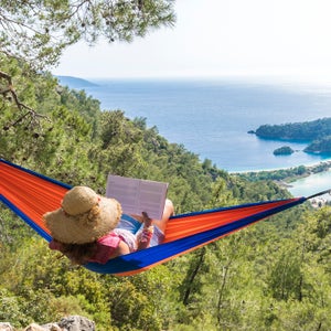 Woman Relaxing In Hammock