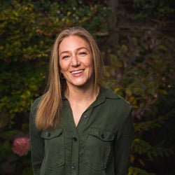 Alyssa Ages smiling in front of trees.