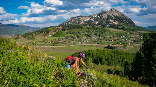 Woman rides trail above Crested Butte