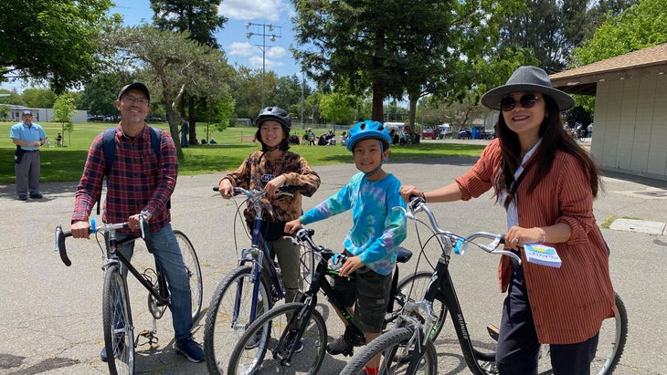 family biking in park in Davis, Calif.