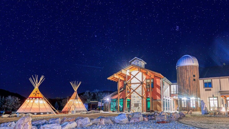 The Compass Rose Lodge, in Utah, is has a large hotel facility and two tepees outdoors. 