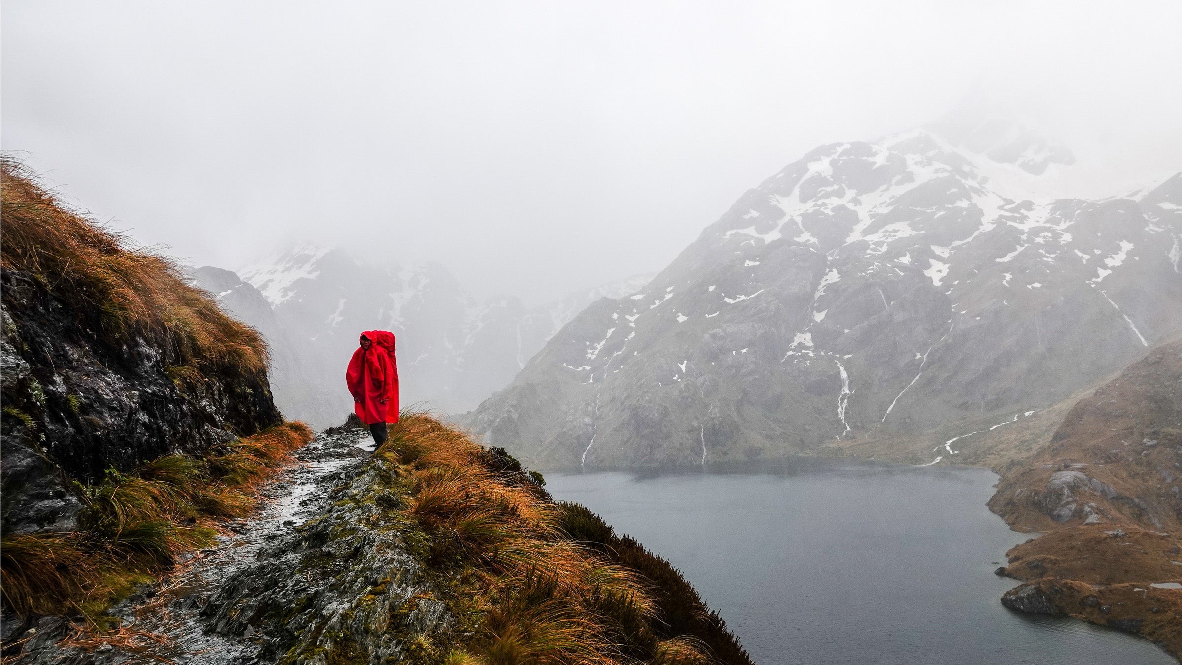 woman hiking in a poncho in New Zealand