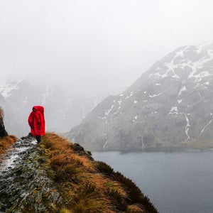 woman hiking in a poncho in New Zealand