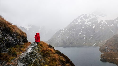 woman hiking in a poncho in New Zealand