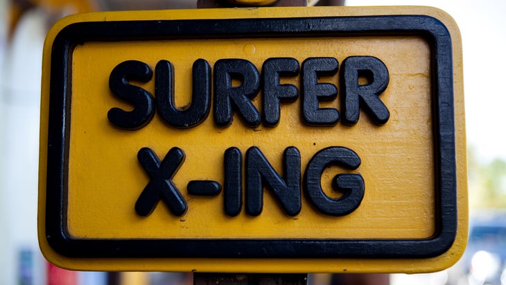 "Surfer X-ing" sign in a surf town