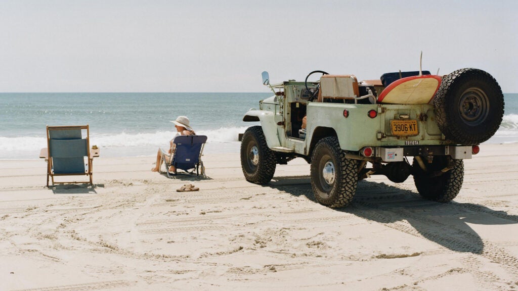 Jeep with surfboard on the beach at Ocracoke Island