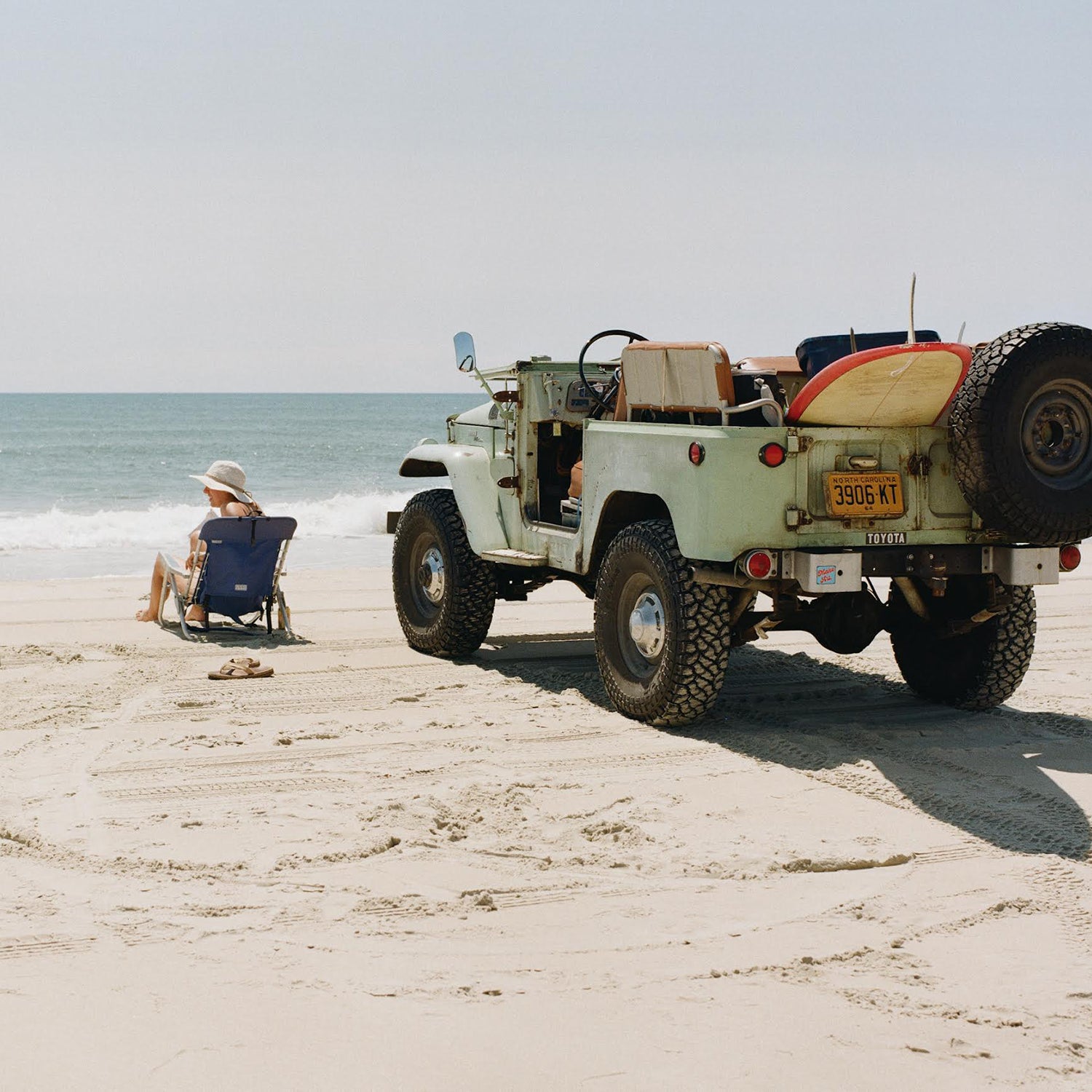 Jeep with surfboard on beach on Ocracoke Island