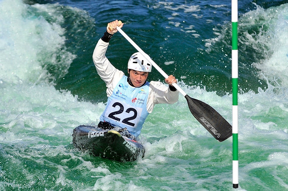 a male paddler in a men's slalom canoe coarse