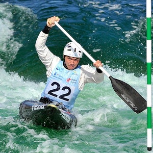a male paddler in a men's slalom canoe coarse