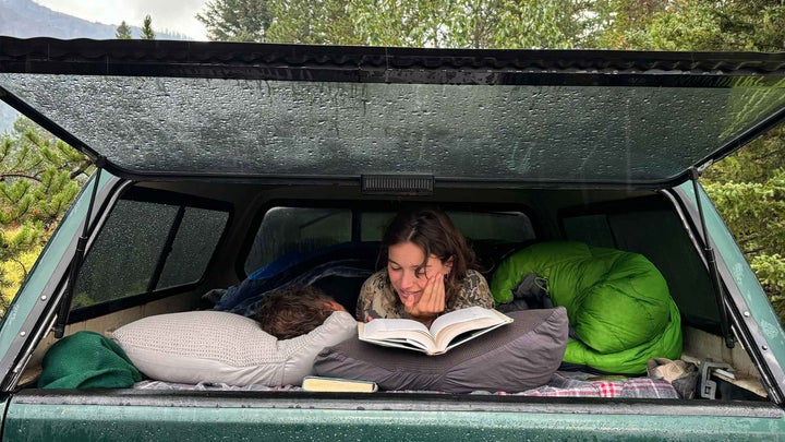 A couple camping in the bed of their truck in Wyoming