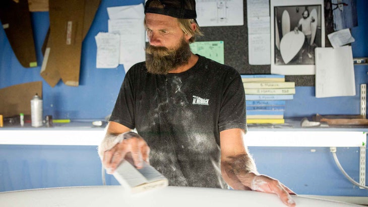 Surfboard shaper Britt Merrick shaping a new board.