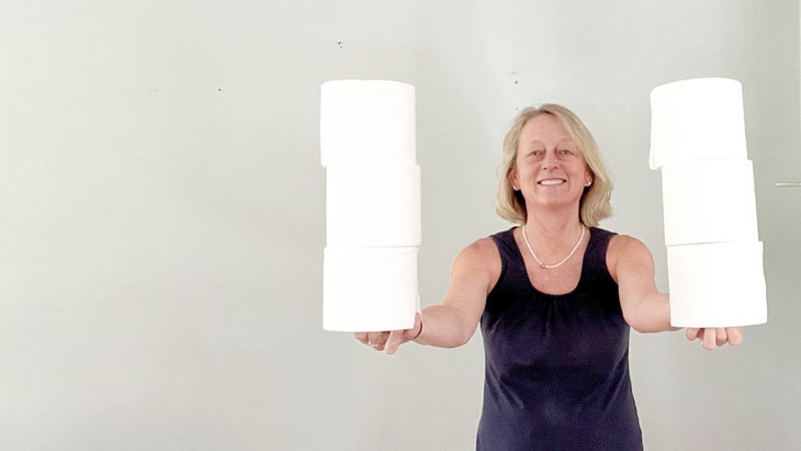 The author holding 6 rolls of toilet paper