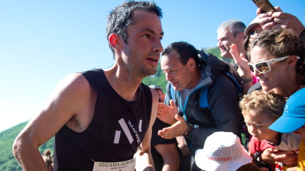 Ultra-racing legend Killian Jornet, running a race as the crowd cheers.