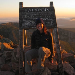 a hiker on top of Katahdin at sunset