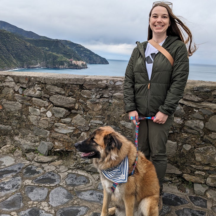 woman and dog in front of village of Cinque Terre