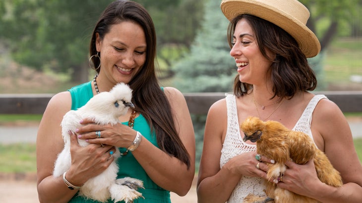 two women pet chickens at Ojo Santa Fe spa