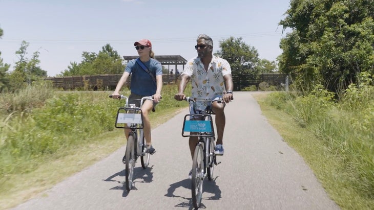 two people biking on a hot day on paved trail