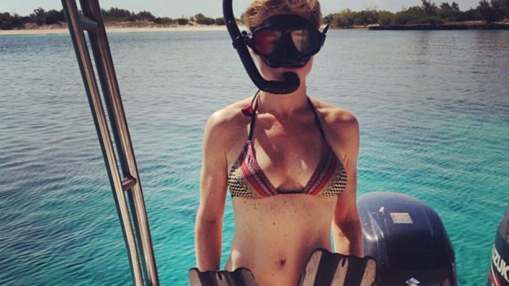 The author on a boat wearing a snorkel mask and carrying fins, ready to jump into the water off Mozambique