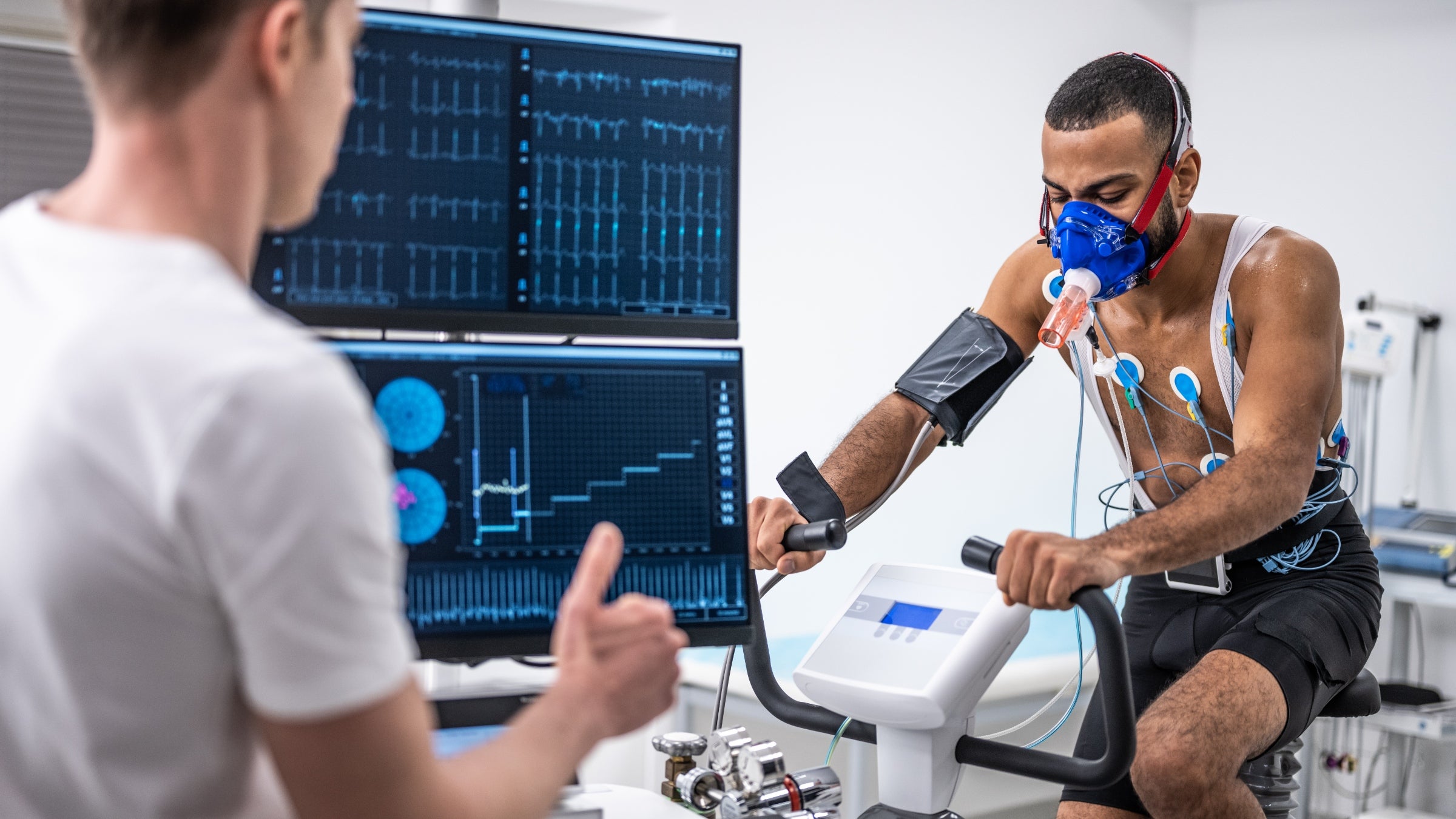 A young man rides a treadmill that tests his vitals, including heart rate variability