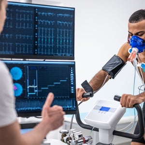 A young man rides a treadmill that tests his vitals, including heart rate variability