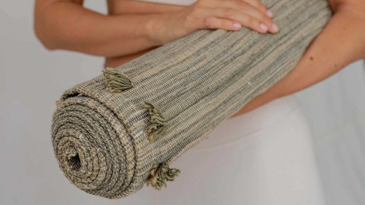 rolled up travel yoga rug