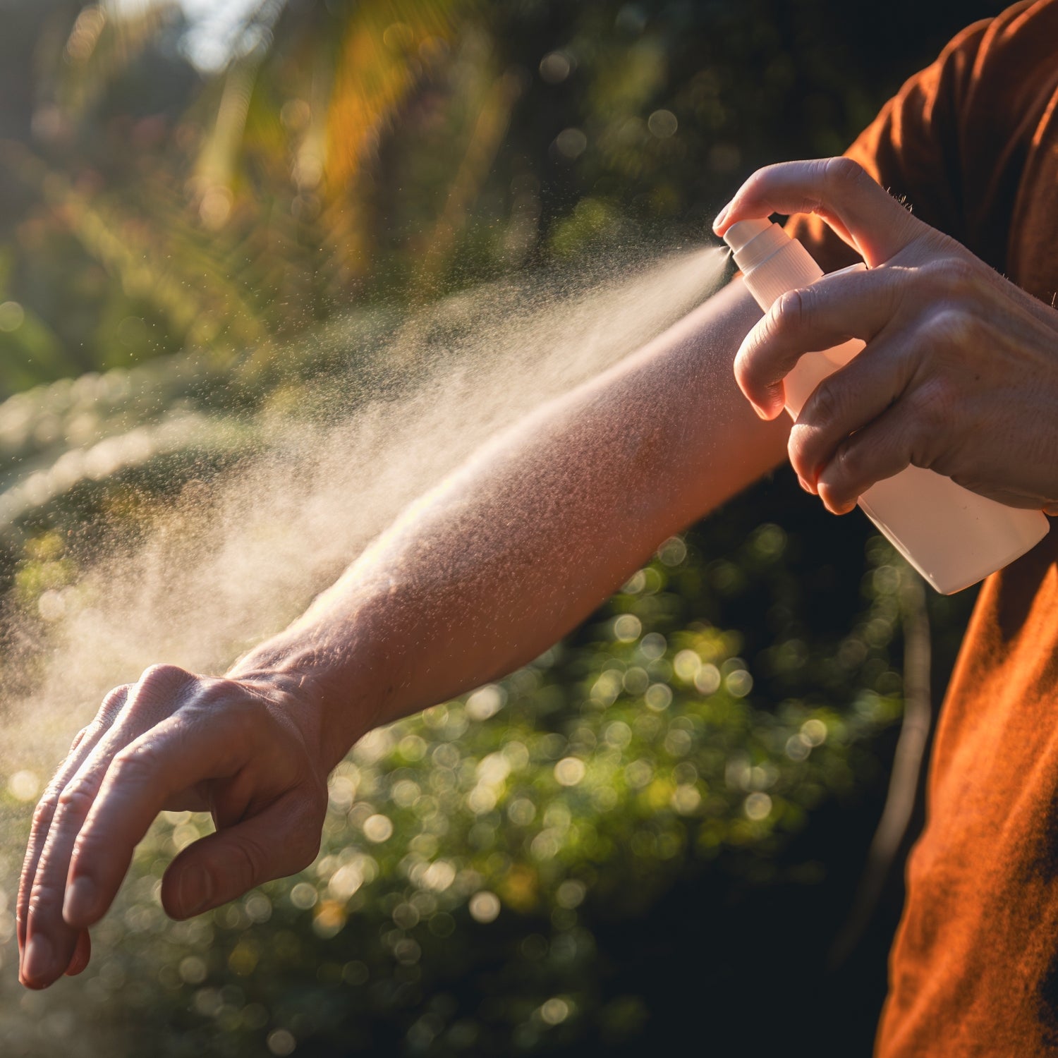 Man while applying insect repellent on his hand. Prevention against mosquito bite in tropical destination.