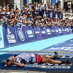 man lying at finish line of utmb race