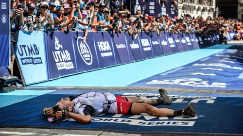 man lying at finish line of utmb race