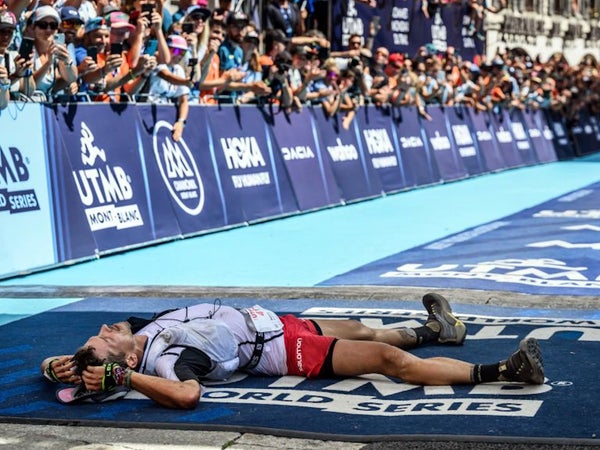 man lying at finish line of utmb race