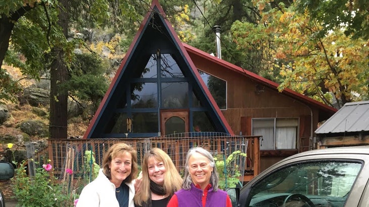 three women in front of an A frame