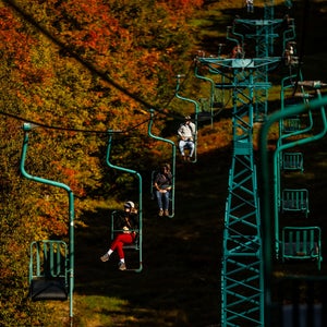 people on chairlift at mad river glen ski area viewing vermont's fall foliage