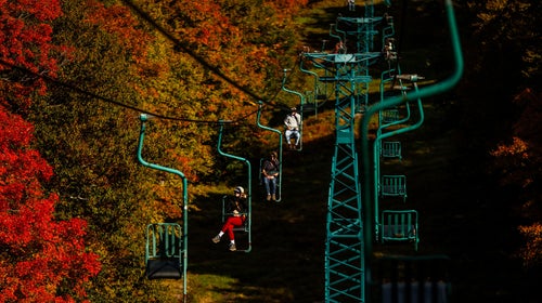 people on chairlift at mad river glen ski area viewing vermont's fall foliage
